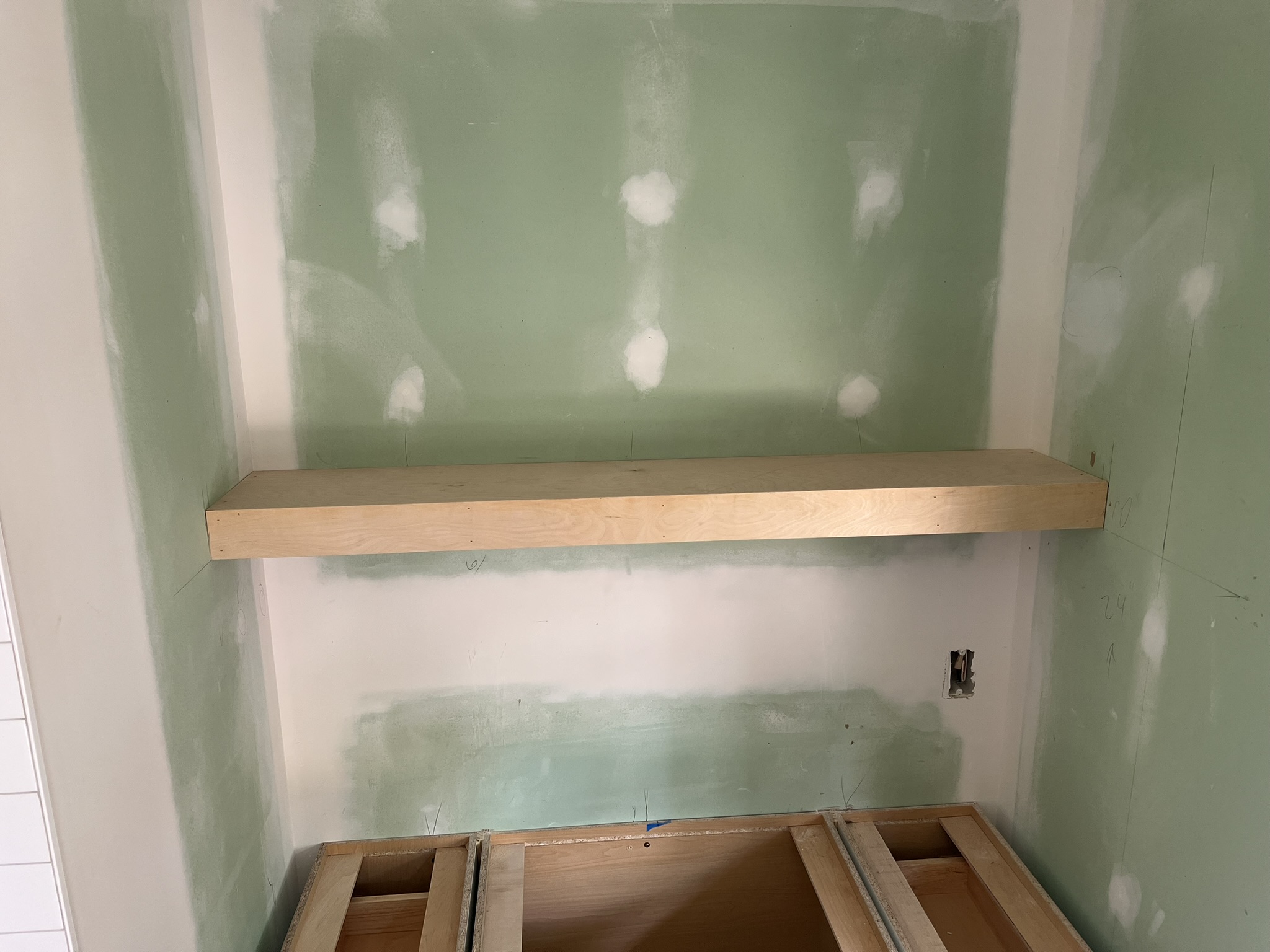 Floating shelf mounted in an alcove during install