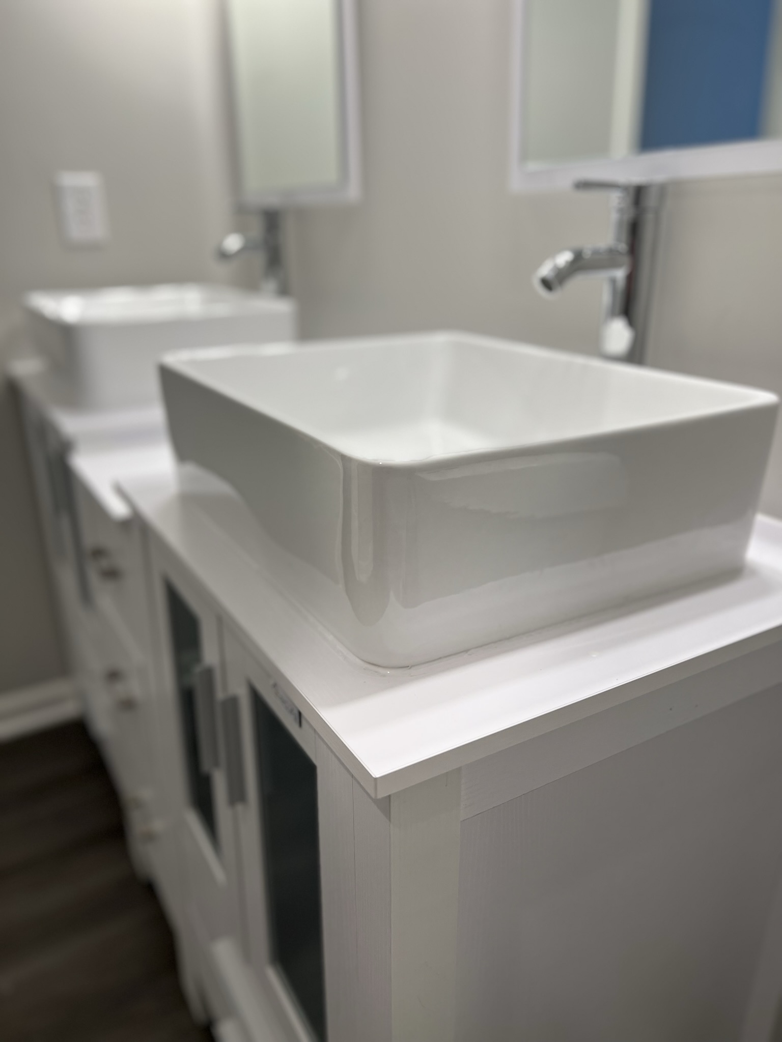 Detail of white vessel sink on custom vanity