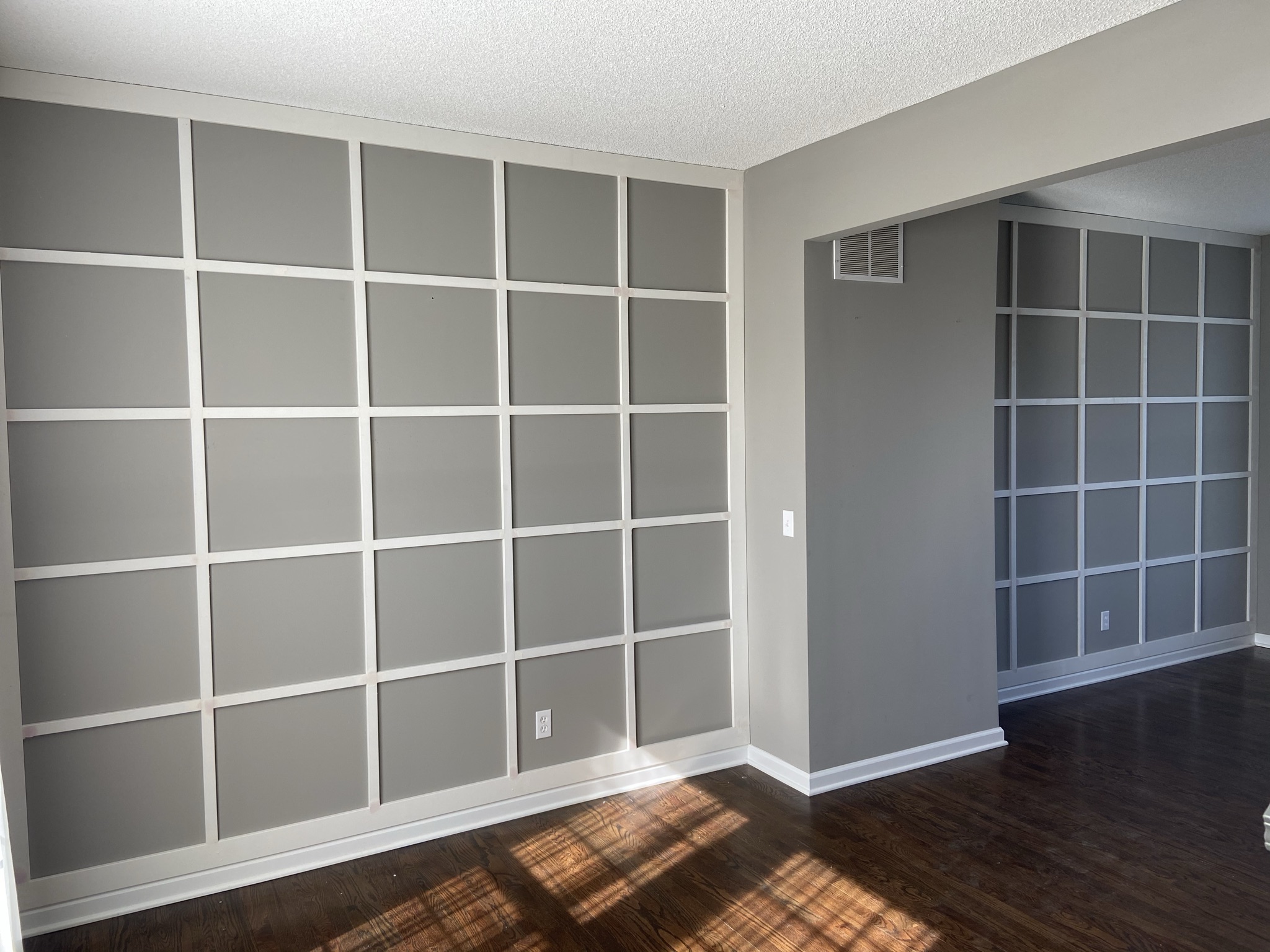Applied moulding grid wall installed on gray primer awaiting finish paint